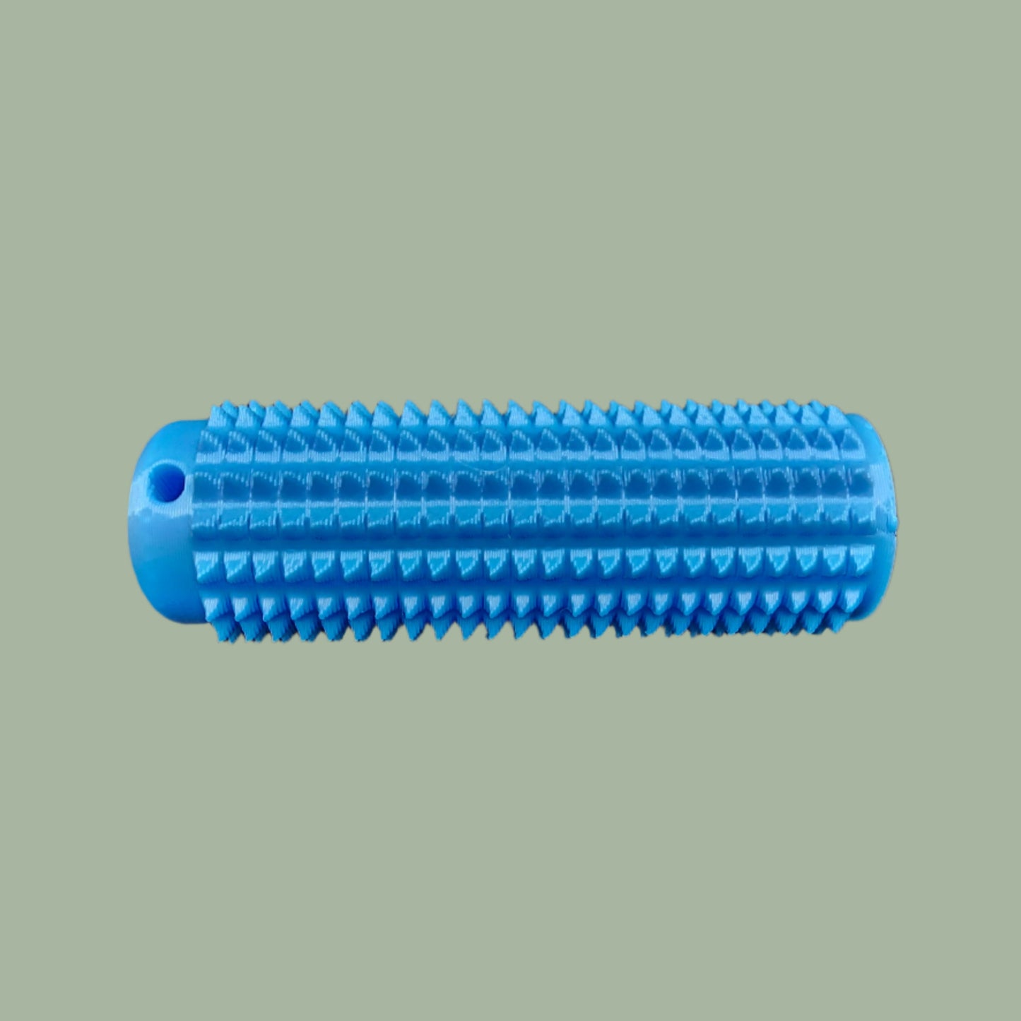 Mini Ouchie Pain Stim – a 7cm long, 3D-printed sensory tool with textured spikes for tactile stimulation, displayed against a neutral background. Includes a keychain for easy portability