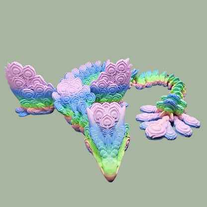 3D-printed Peacock Dragon figurine in pastel rainbow colours, featuring intricate feather-like scales and an articulated body. Handmade in the UK, available in medium, large, and X-large, with or without wings. A stunning, poseable dragon perfect for collectors and fantasy lovers