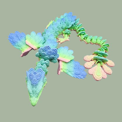 3D-printed Peacock Dragon figurine in pastel rainbow colours, featuring intricate feather-like scales and an articulated body. Handmade in the UK, available in medium, large, and X-large, with or without wings. A stunning, poseable dragon perfect for collectors and fantasy lovers