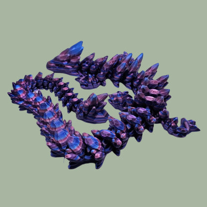 3D printed articulated dragon in a purple, blue, and pink colour