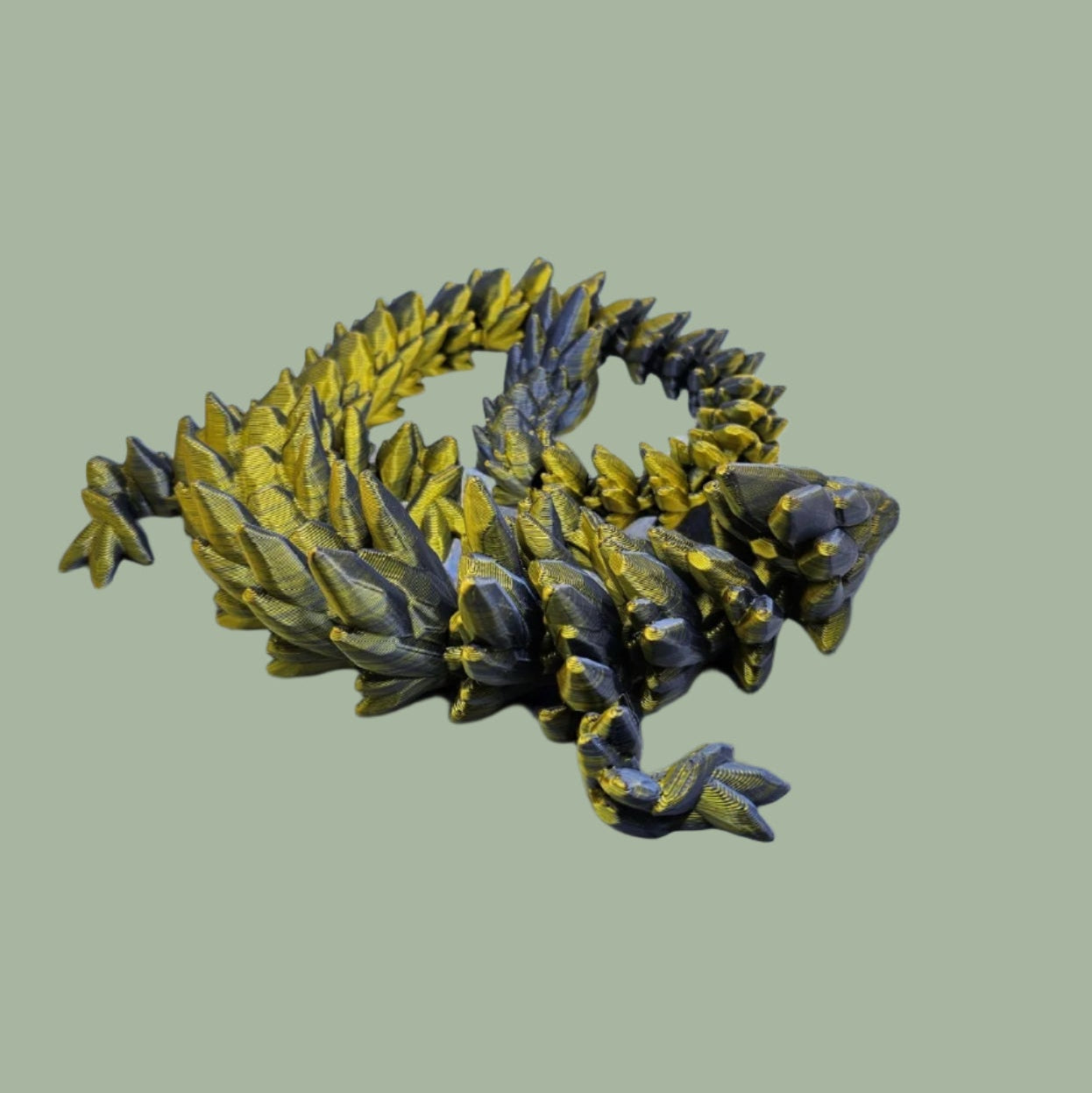3D printed articulated dragon in a gold and blue colour