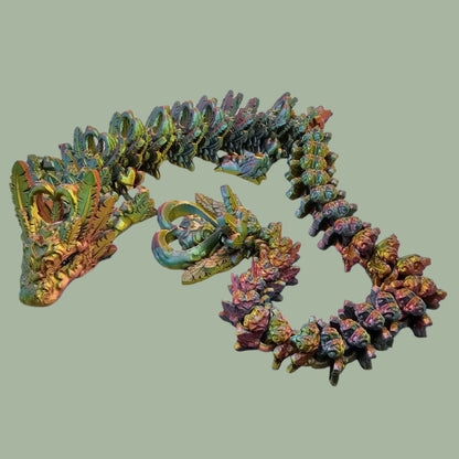 3D printed articulated dragon with heart details along the body and a spinning heart in the tail
