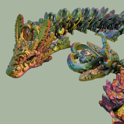 3D printed articulated dragon with heart details along the body and a spinning heart in the tail