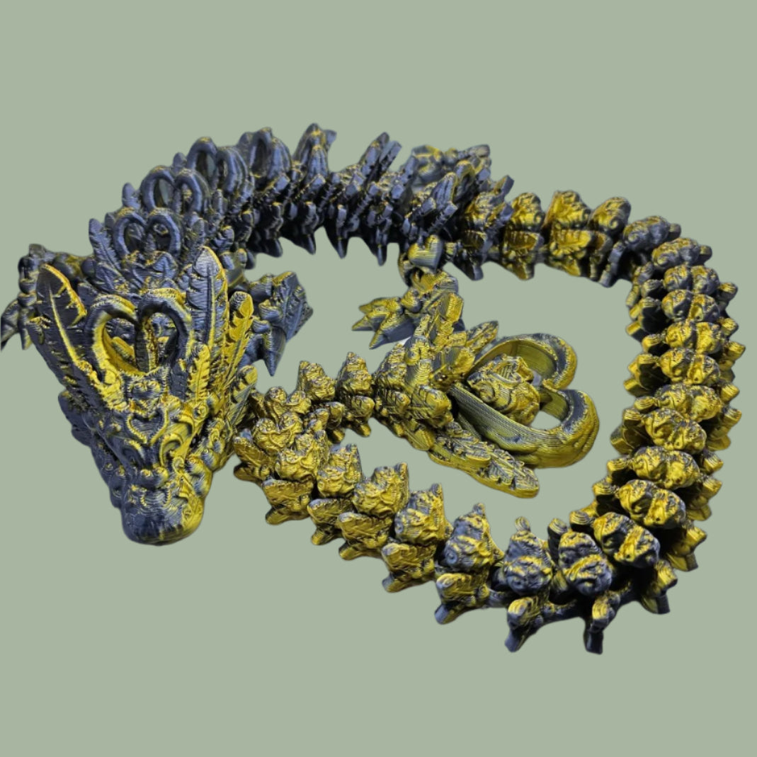 3D printed articulated dragon with heart details along the body and a spinning heart in the tail
