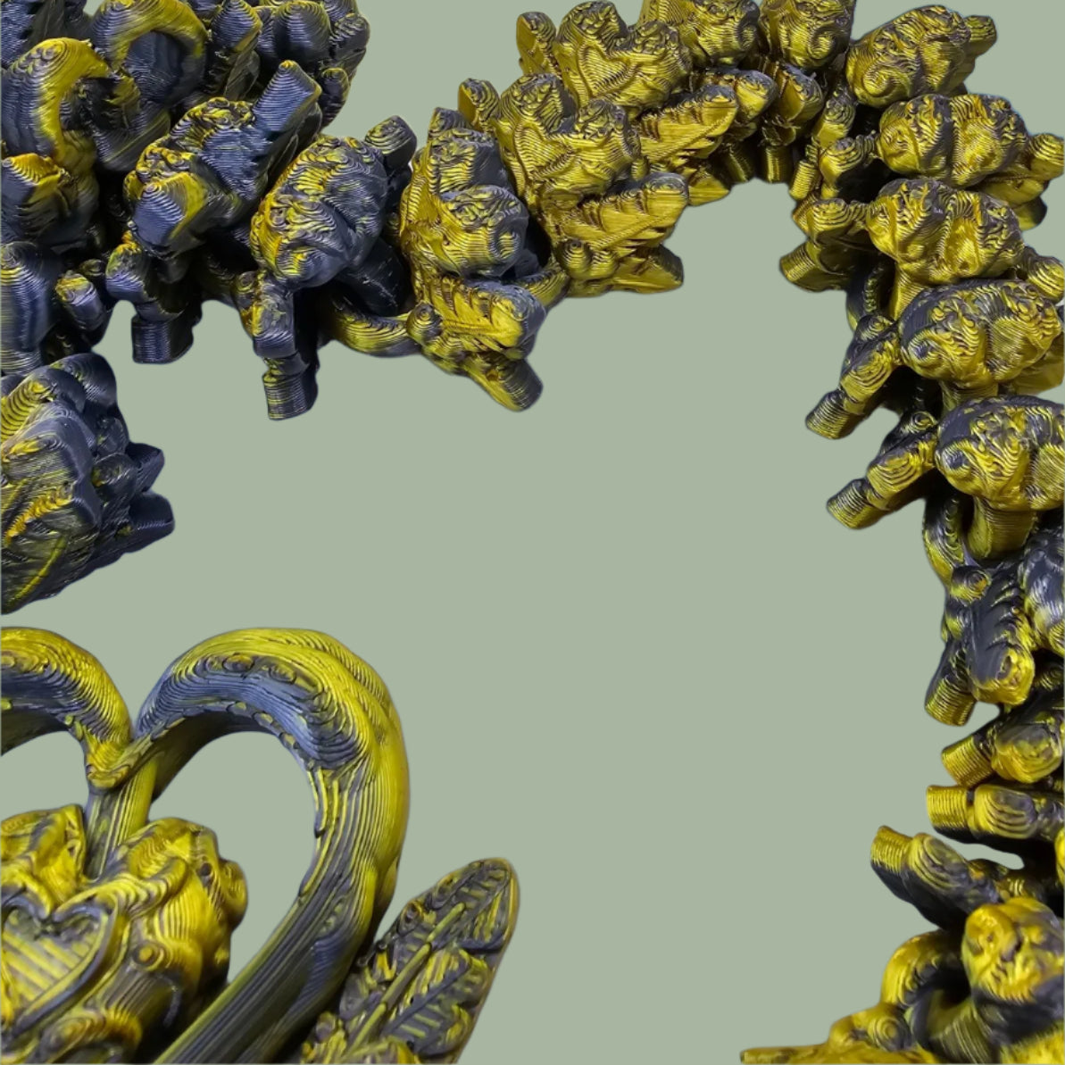 3D printed articulated dragon with heart details along the body and a spinning heart in the tail