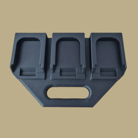 Black 3D printed battery caddy holding six Makita-compatible batteries with built-in carry handle