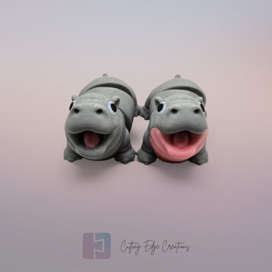 Pair of 3D printed happy flexi baby hippos, one with a pink throat/neck