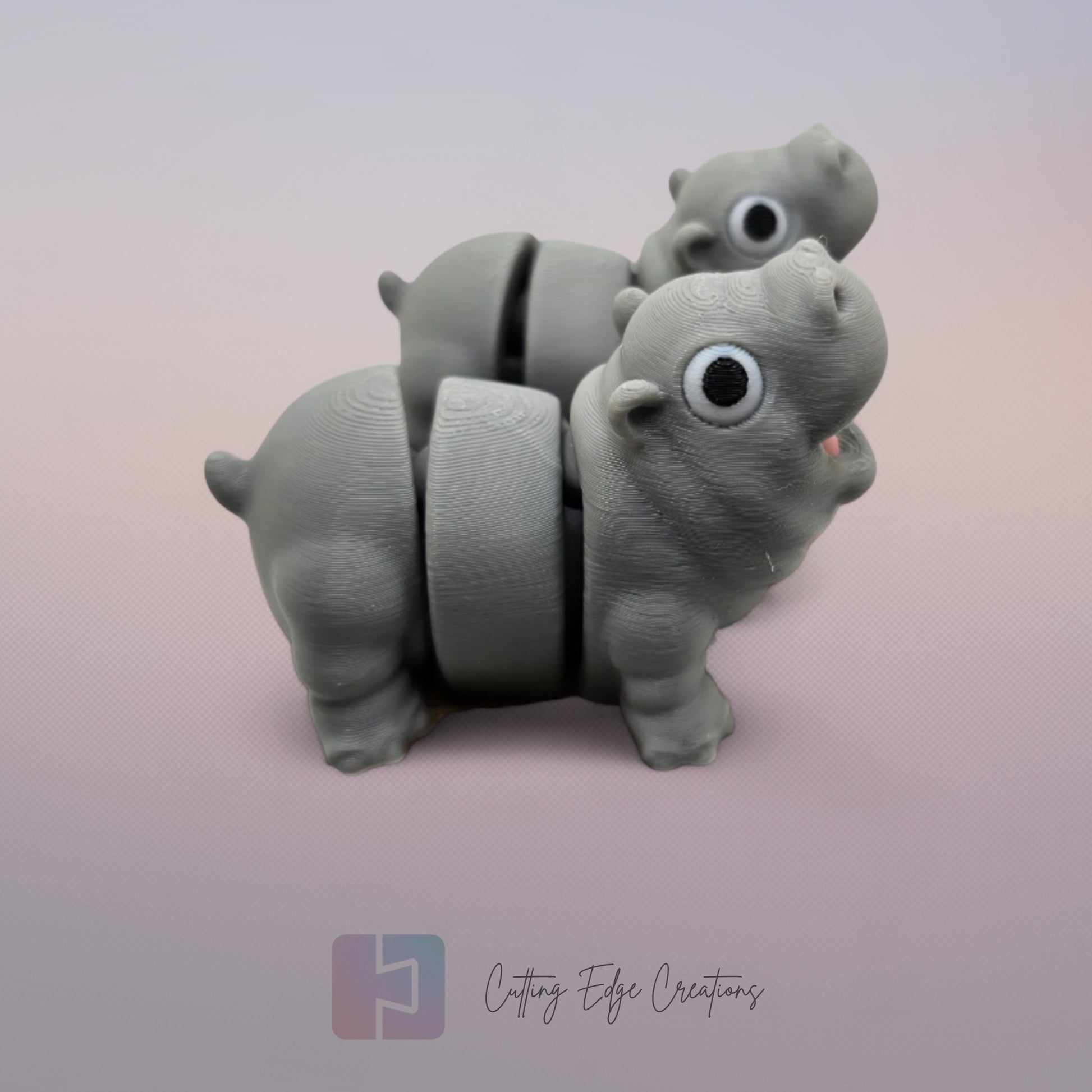 Pair of 3D printed happy flexi baby hippos, one with a pink throat/neck