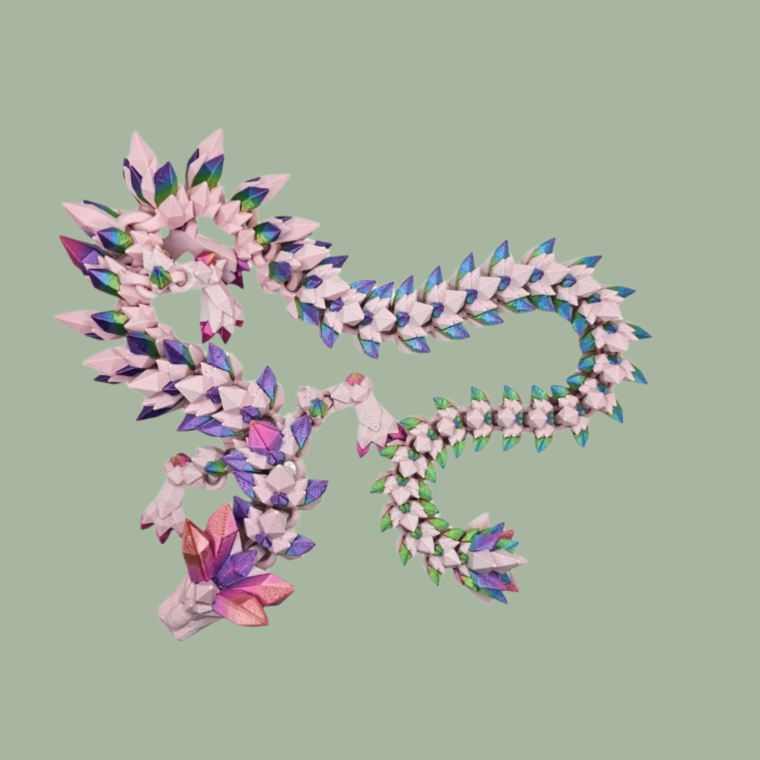 3D printed crystal style dragon in pink with rainbow detail along the body