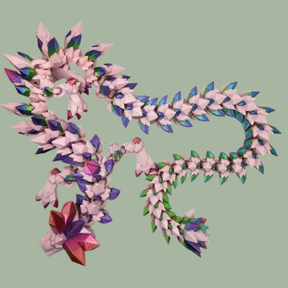 3D printed crystal style dragon in pink with rainbow detail along the body