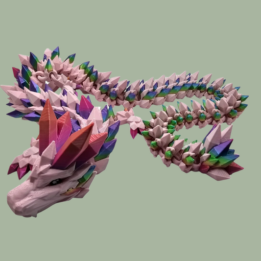 3D printed crystal style dragon in pink with rainbow detail along the body