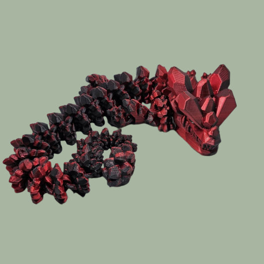 3D printed articulated dragon with rock detail, in a red/black colour
