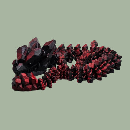 3D printed articulated dragon with rock detail, in a red/black colour