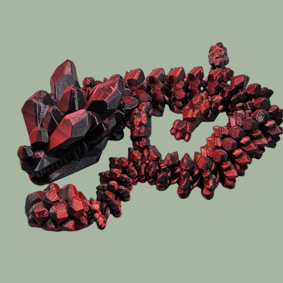 3D printed articulated dragon with rock detail, in a red/black colour