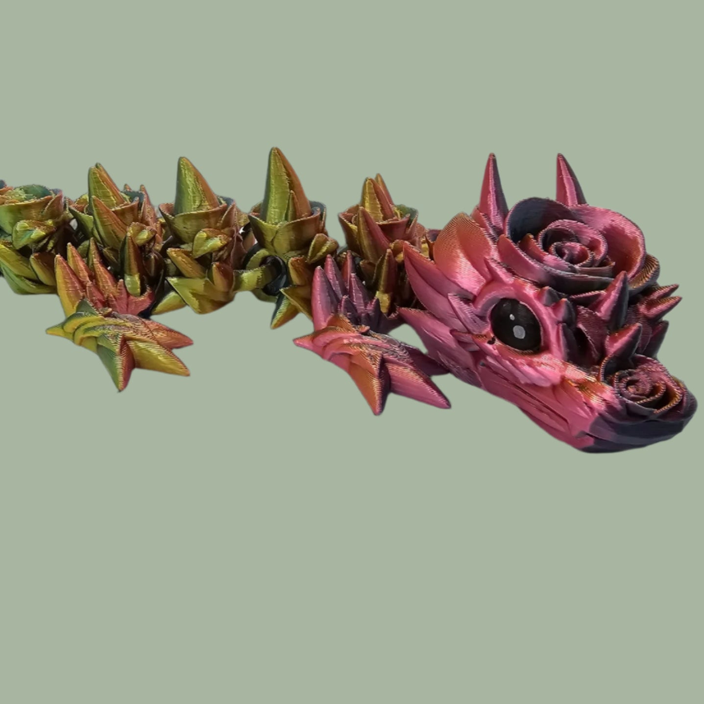 3D printed articulated dragon with rose details along the body