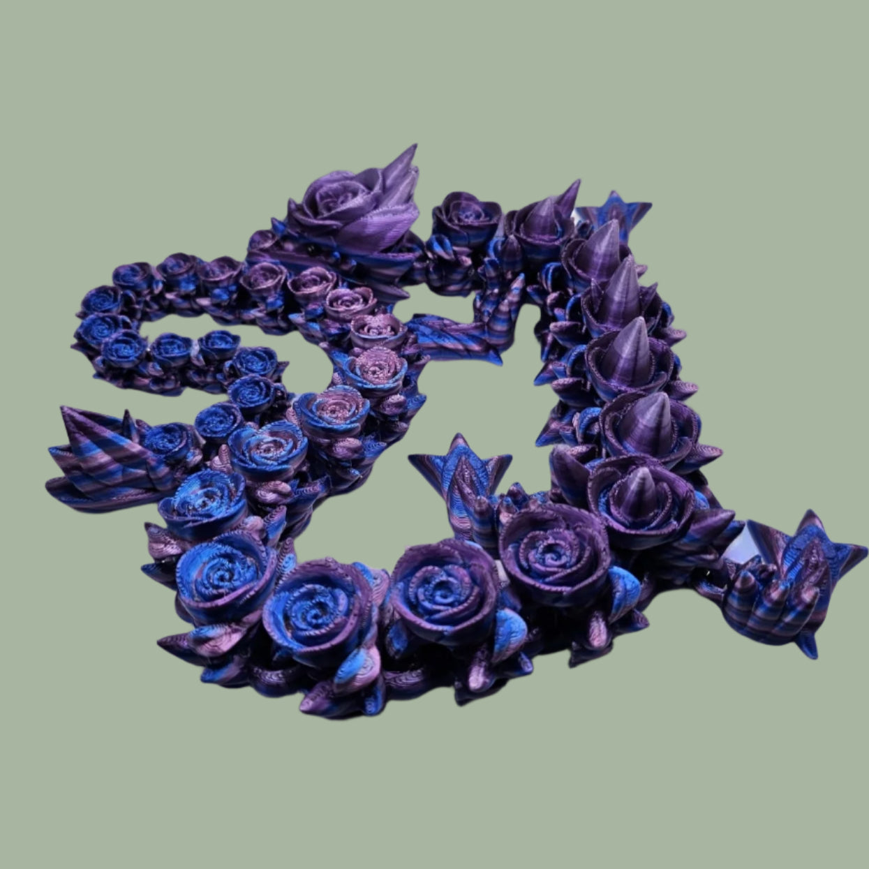 3D printed articulated dragon with rose details along the body