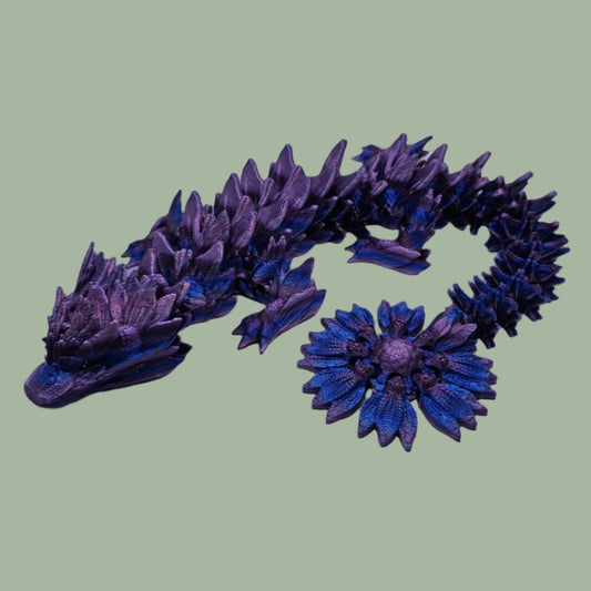 3D printed articulated dragon with sunflower detail, in a purple/blue/pink  colour