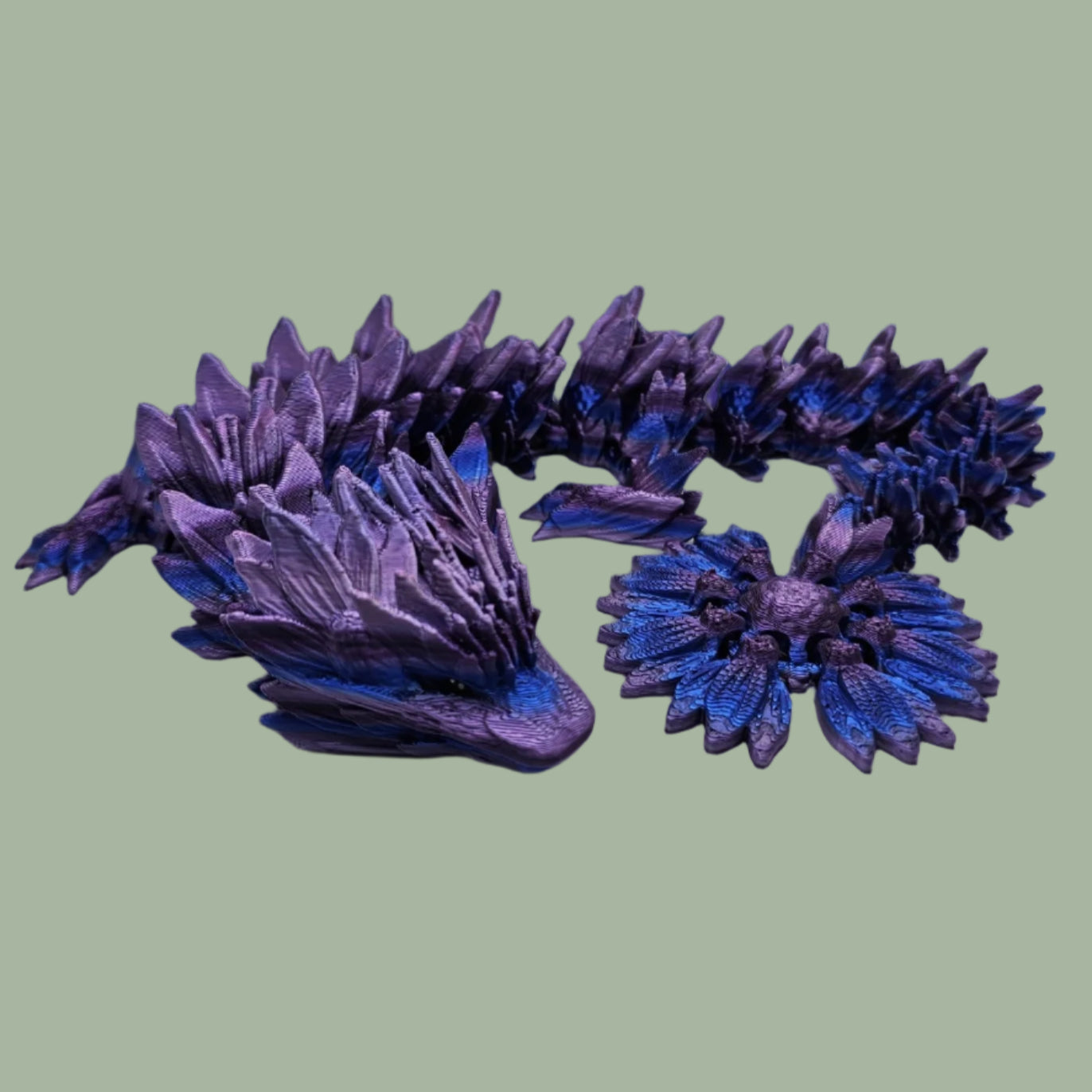 3D printed articulated dragon with sunflower detail, in a purple/blue/pink  colour