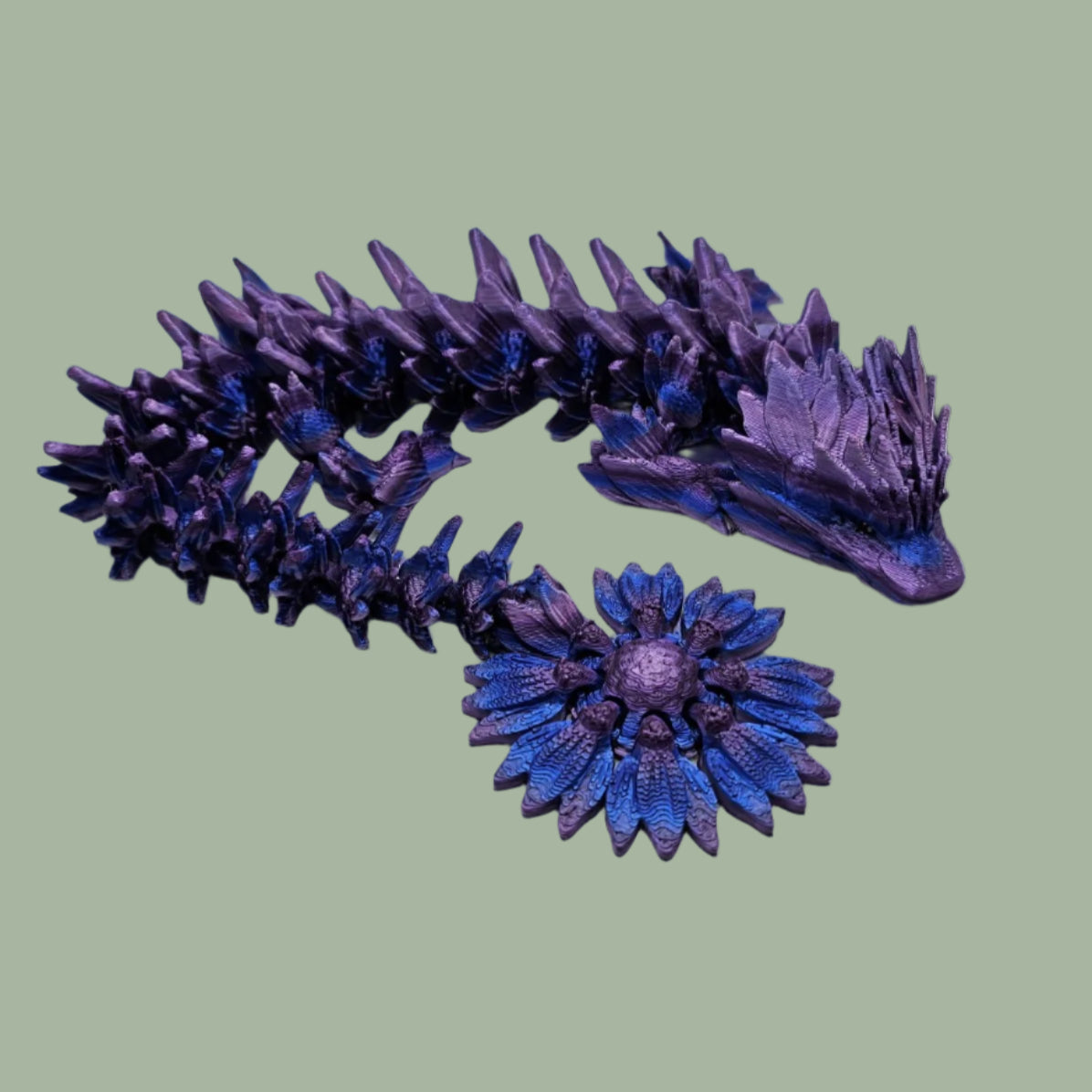 3D printed articulated dragon with sunflower detail, in a purple/blue/pink  colour