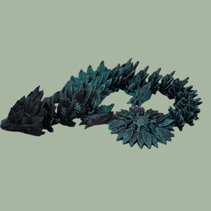 3D printed articulated dragon with sunflower detail, in a black/green colour