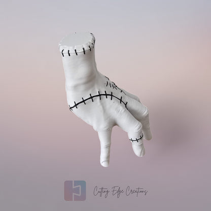 Close-up of white 3D printed stitched hand model, creepy Addams Family style ornament