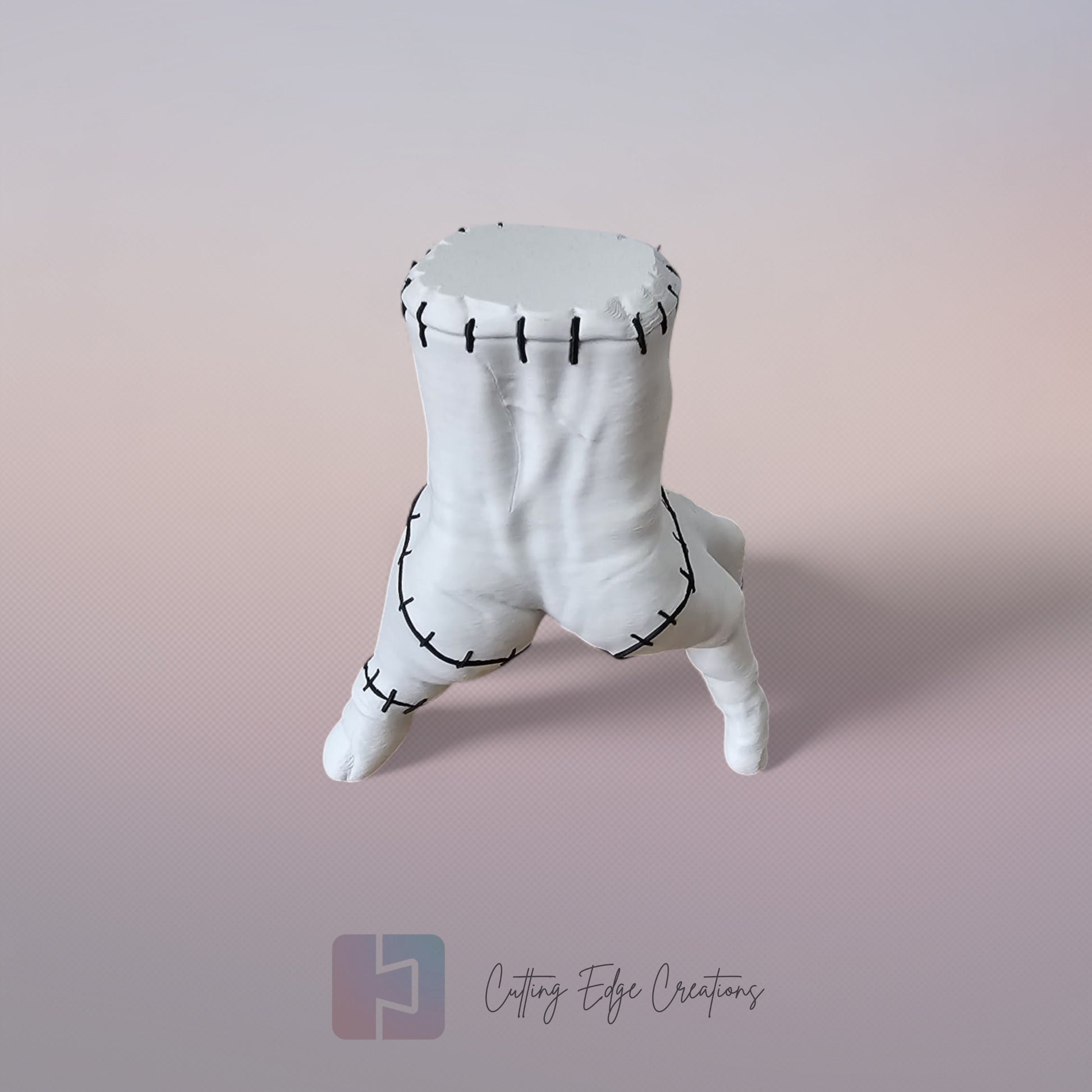 Close-up of white 3D printed stitched hand model, creepy Addams Family style ornament