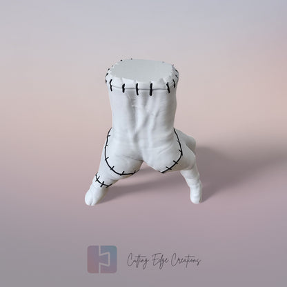 Close-up of white 3D printed stitched hand model, creepy Addams Family style ornament