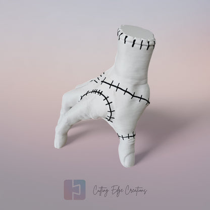 Close-up of white 3D printed stitched hand model, creepy Addams Family style ornament