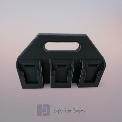 Black 3D printed battery caddy compatible with DeWalt batteries holding six batteries on wooden workbench in workshop.