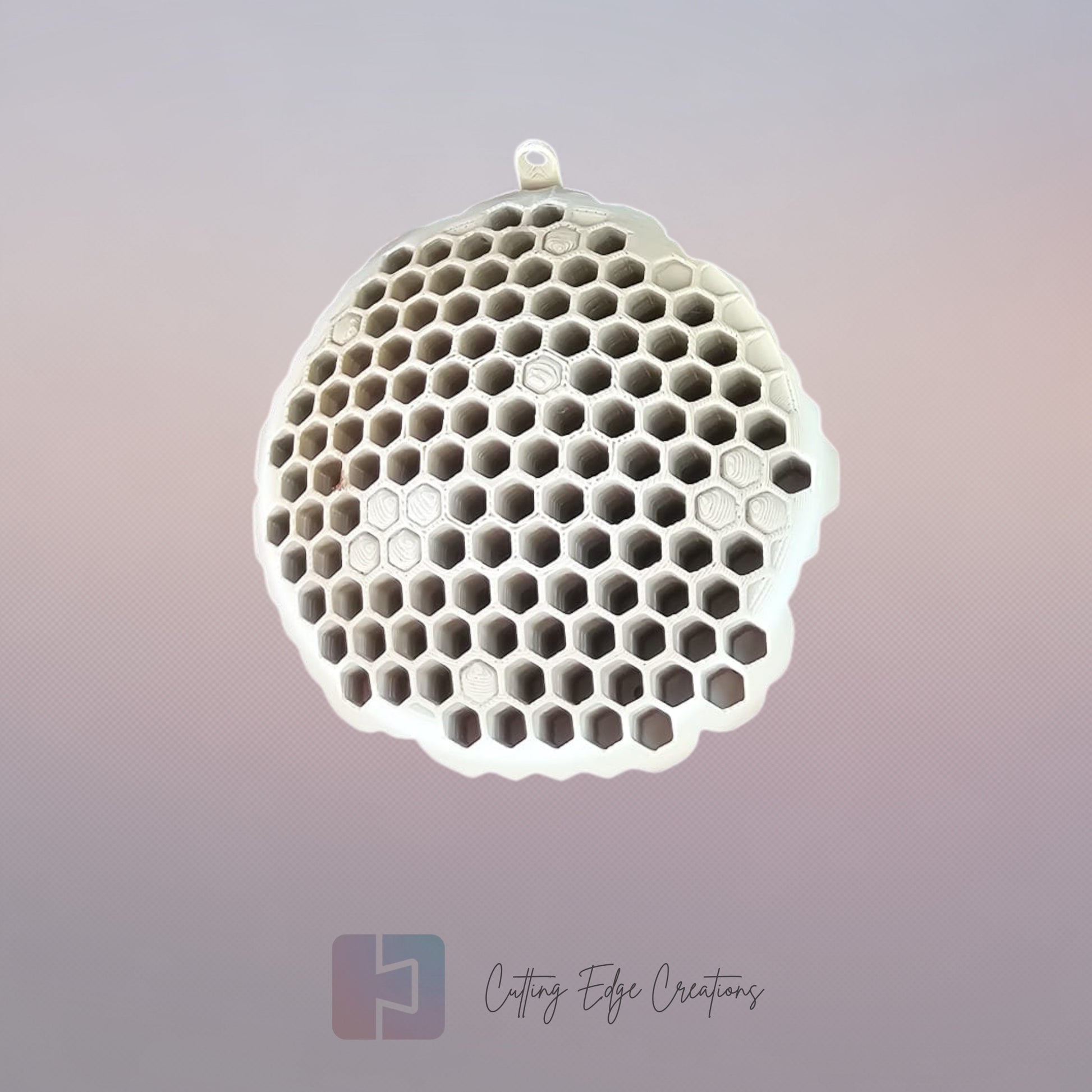 A 3D printed fake wasp nest with a honeycomb pattern, mounted under a wooden shed roof to deter real wasps.