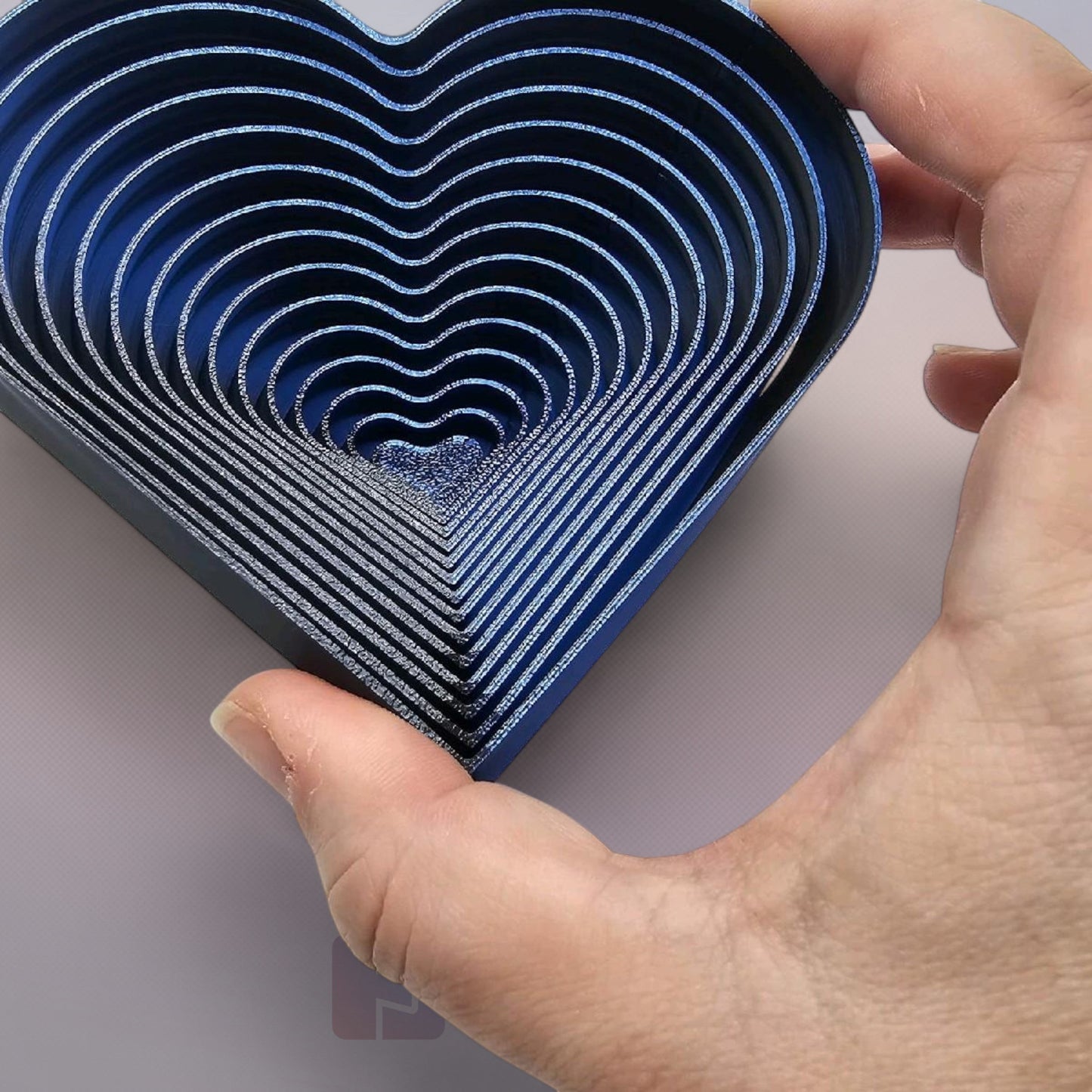 Cutting Edge Creations blue interlocking flexi heart fidget toy made from bio-filament.