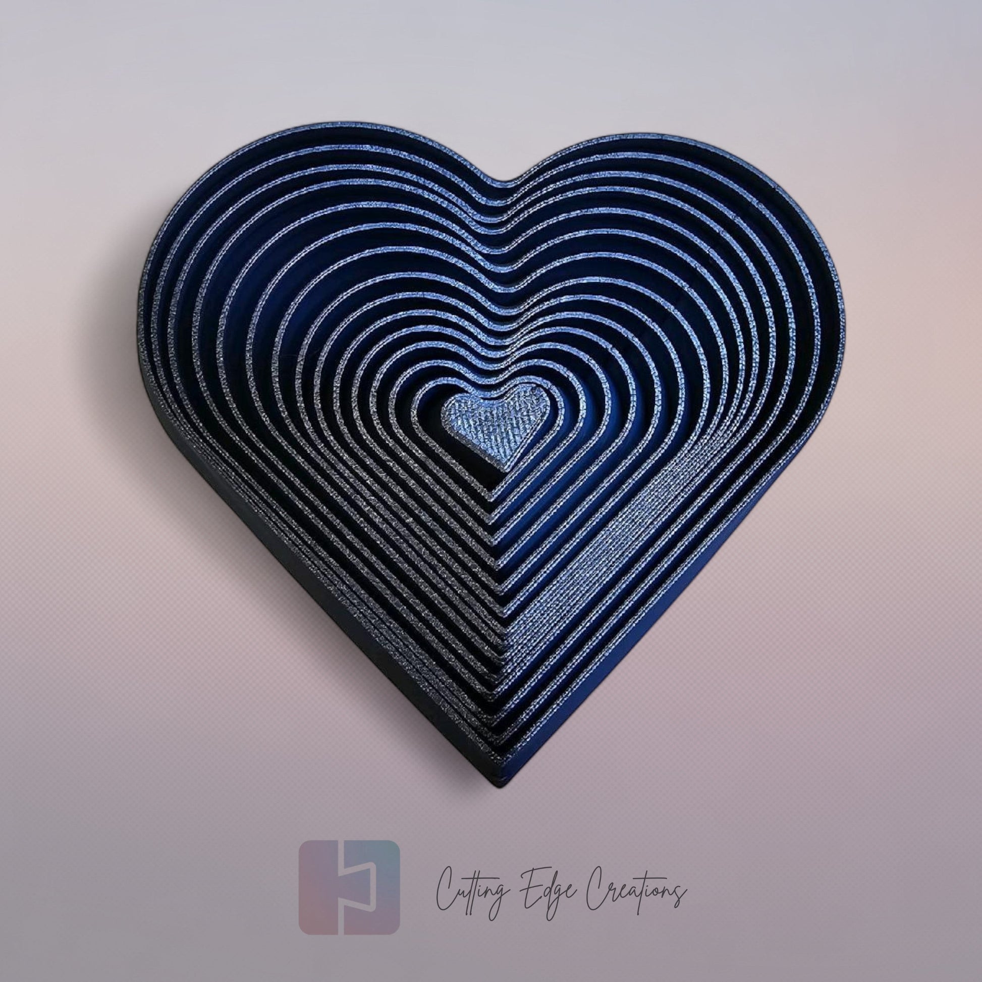 Cutting Edge Creations interlocking flexi heart fidget toy, 3D printed in dark blue bio-filament.