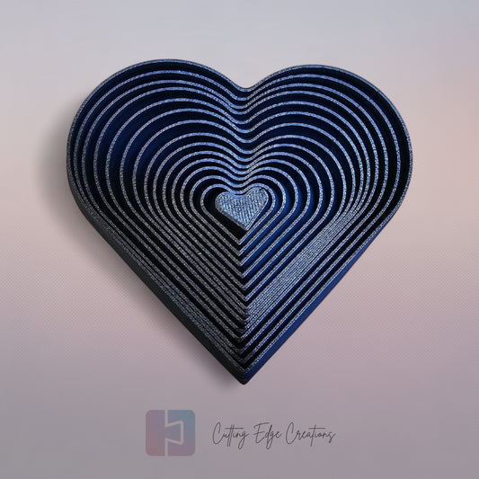 Cutting Edge Creations interlocking flexi heart fidget toy, 3D printed in dark blue bio-filament.