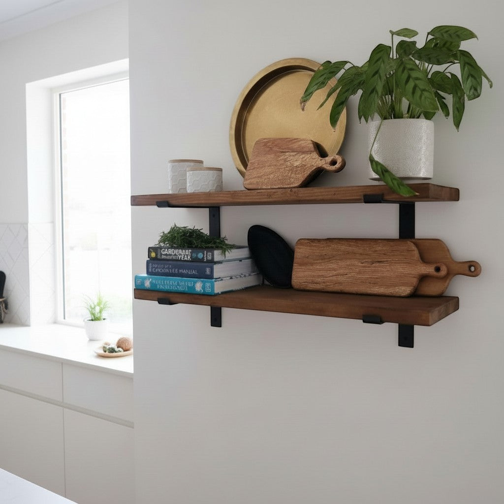 Cutting Edge Creations rustic reclaimed timber scaffold board shelf with black brackets, styled with chopping boards, books, and a plant.