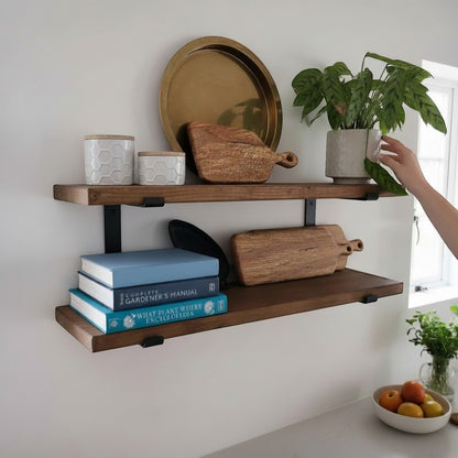 Cutting Edge Creations rustic reclaimed timber scaffold board shelf with black brackets, styled with decorative items and books.