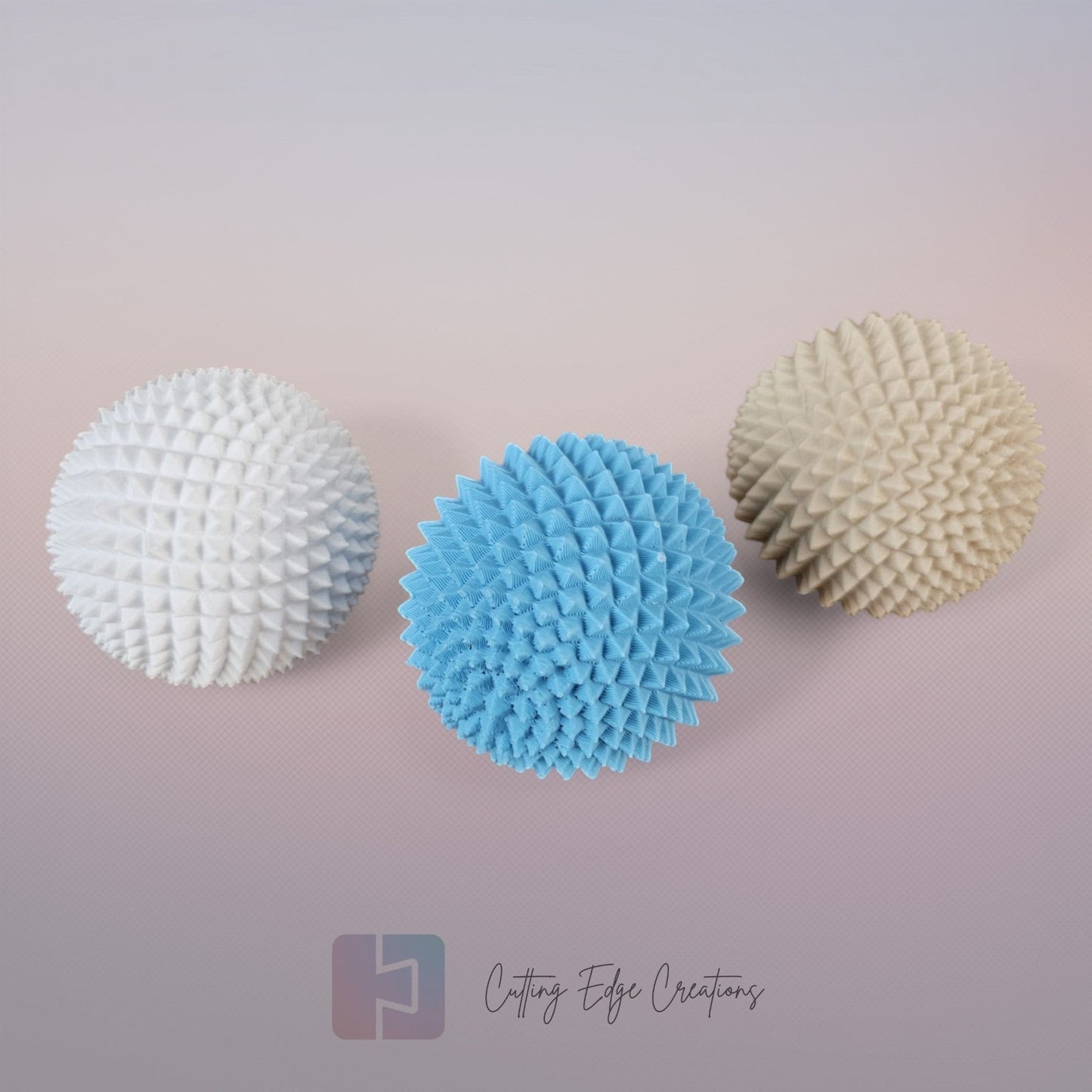 Cutting Edge Creations Spike Sphere fidget toy, 5cm textured polymer ball with micro-spikes in white, blue, and beige.
