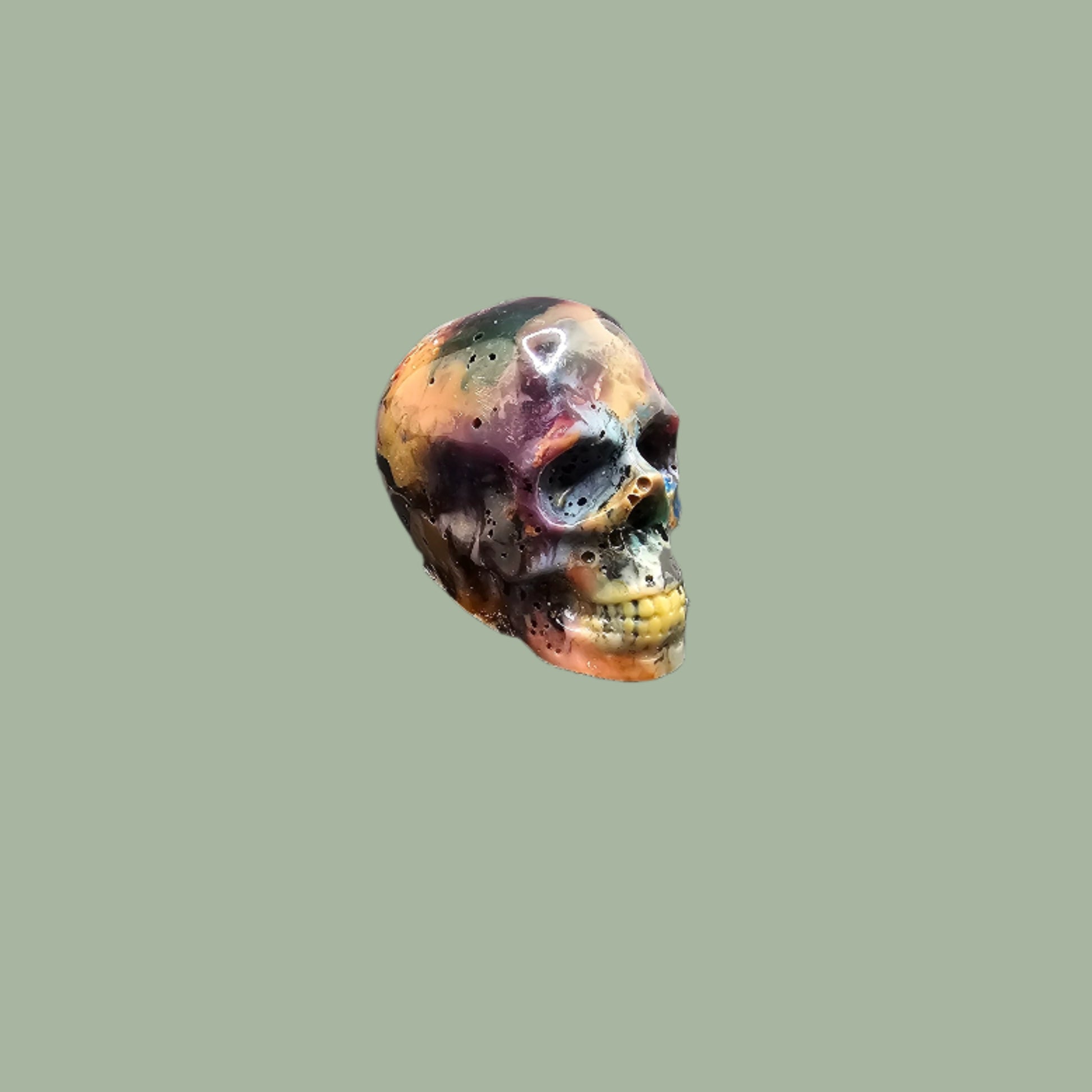 Colourful recycled filament skulls in large, medium, and small sizes, made from 3D printing waste. Each skull is unique, featuring a mix of random colours. Eco-friendly and sustainable home decor