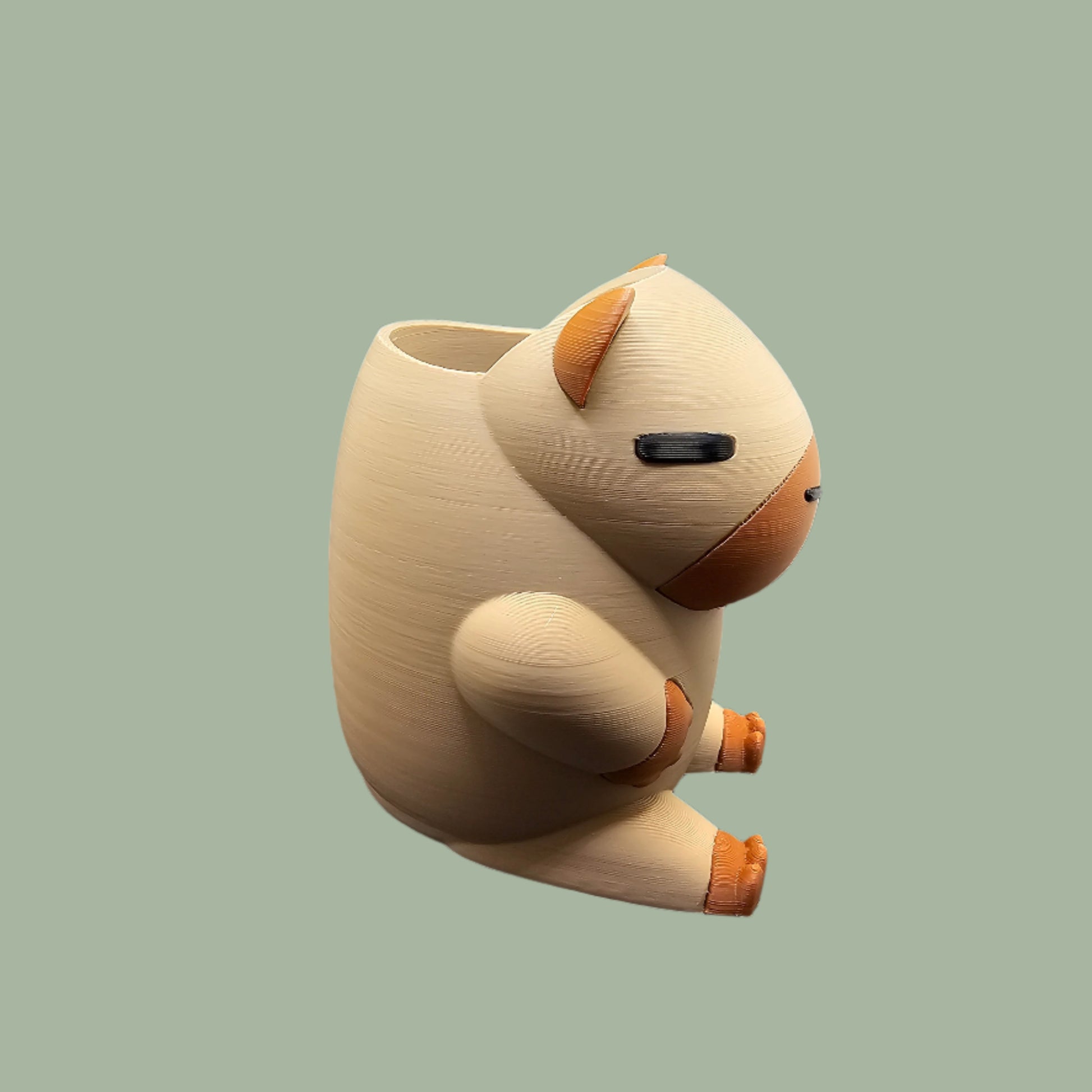 3D printed Capybara Pen Pot in a cute cartoon style, holding pens upright. A fun and functional desk organiser, designed and made in the UK. Perfect for stationery storage and office decor