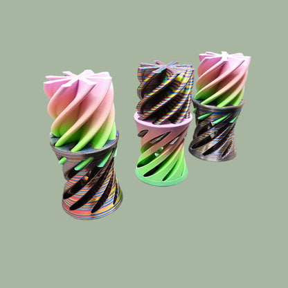 3D-printed Infinity Tubes in pastel and rainbow colours, featuring a spiral fidget design. Small, portable sensory toy made in the UK for stress relief and endless fidgeting
