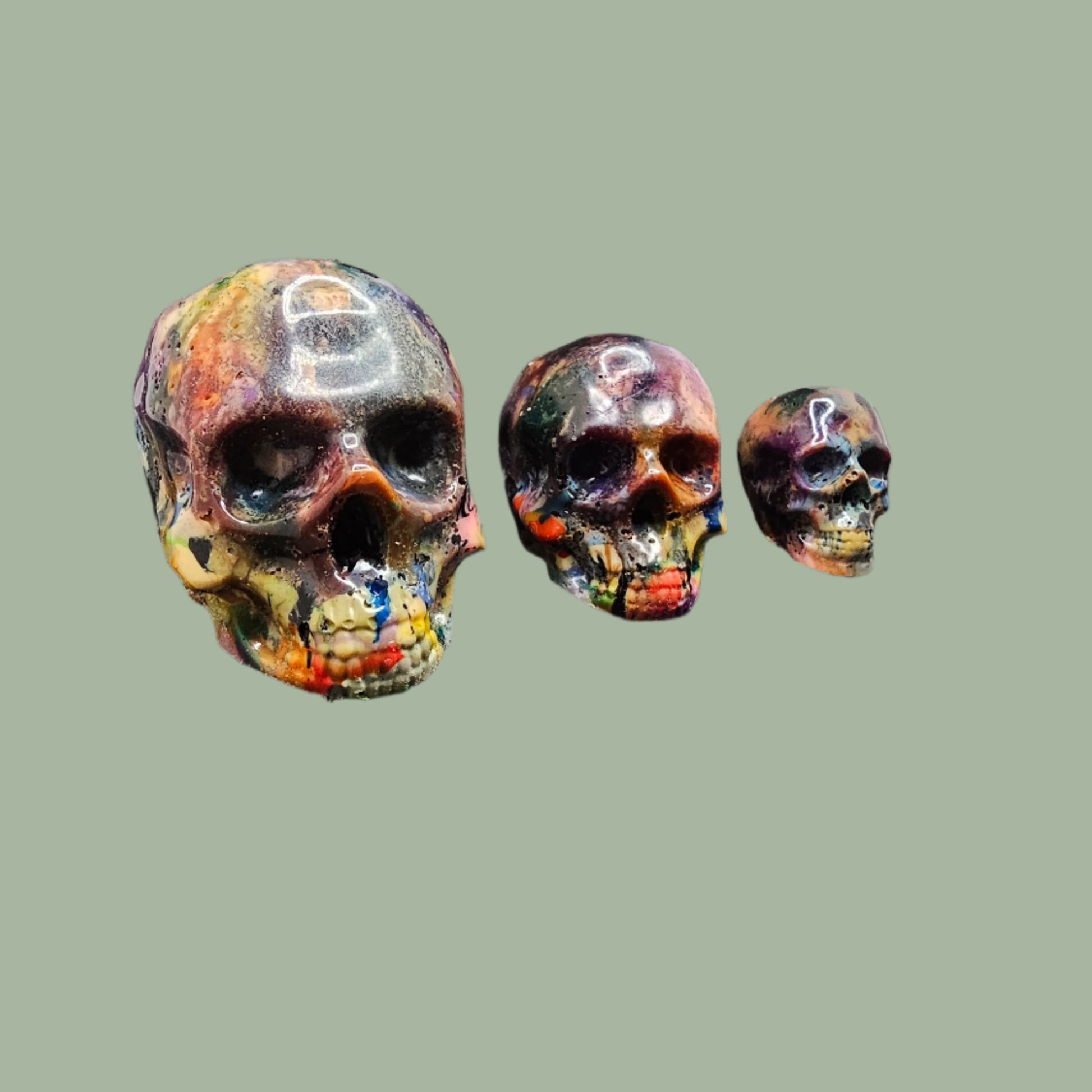 Colourful recycled filament skulls in large, medium, and small sizes, made from 3D printing waste. Each skull is unique, featuring a mix of random colours. Eco-friendly and sustainable home decor