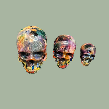 Colourful recycled filament skulls in large, medium, and small sizes, made from 3D printing waste. Each skull is unique, featuring a mix of random colours. Eco-friendly and sustainable home decor
