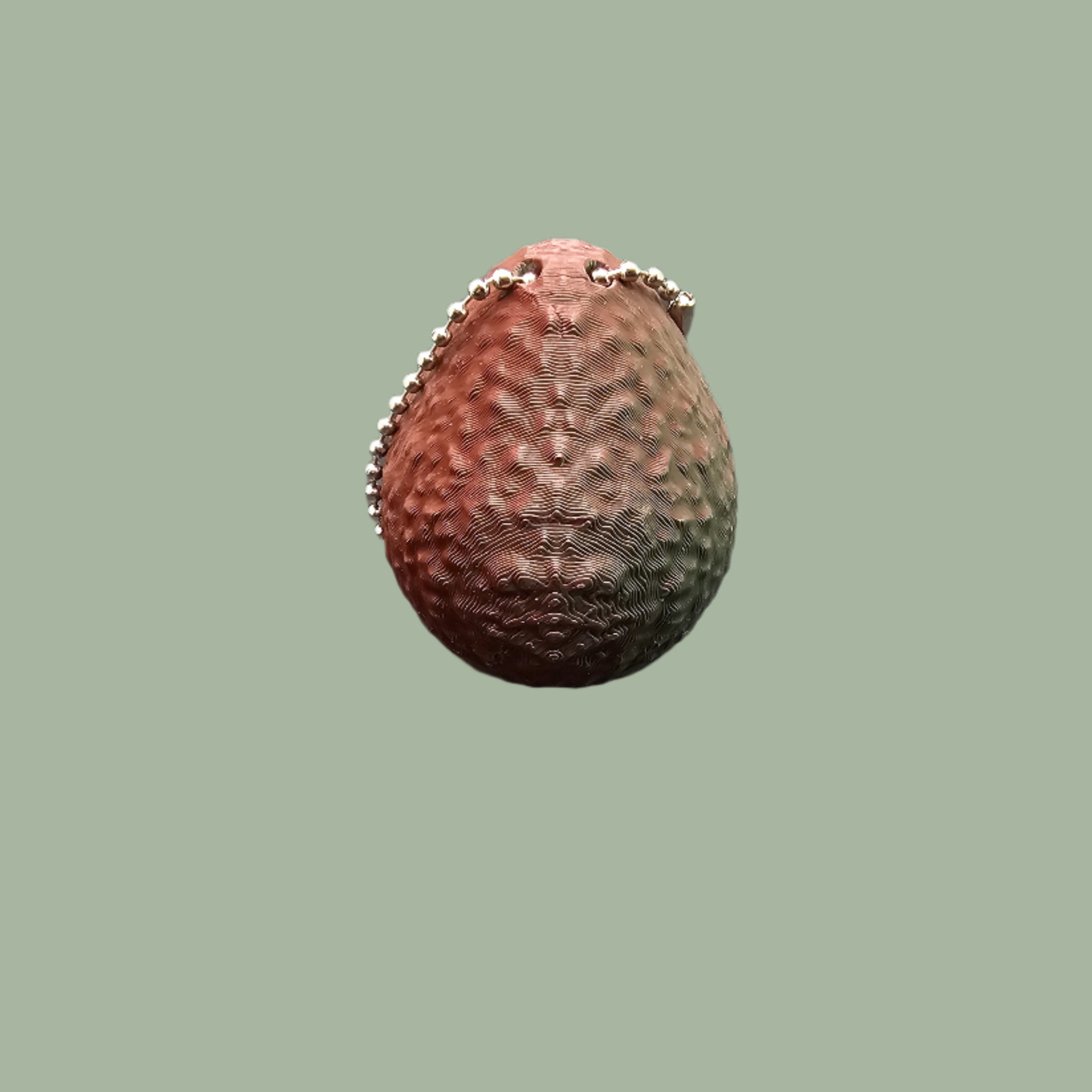 Cute 3D-printed avocado fidget clicker keychain with a heart-shaped clickable stone. Small stress relief toy, 5.5cm tall, made in the UK. Perfect for fidgeting, anxiety relief, and as a fun keyring accessory