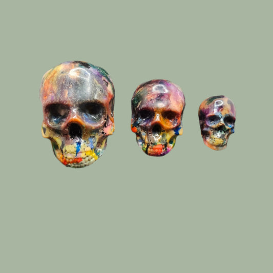 Colourful recycled filament skulls in large, medium, and small sizes, made from 3D printing waste. Each skull is unique, featuring a mix of random colours. Eco-friendly and sustainable home decor