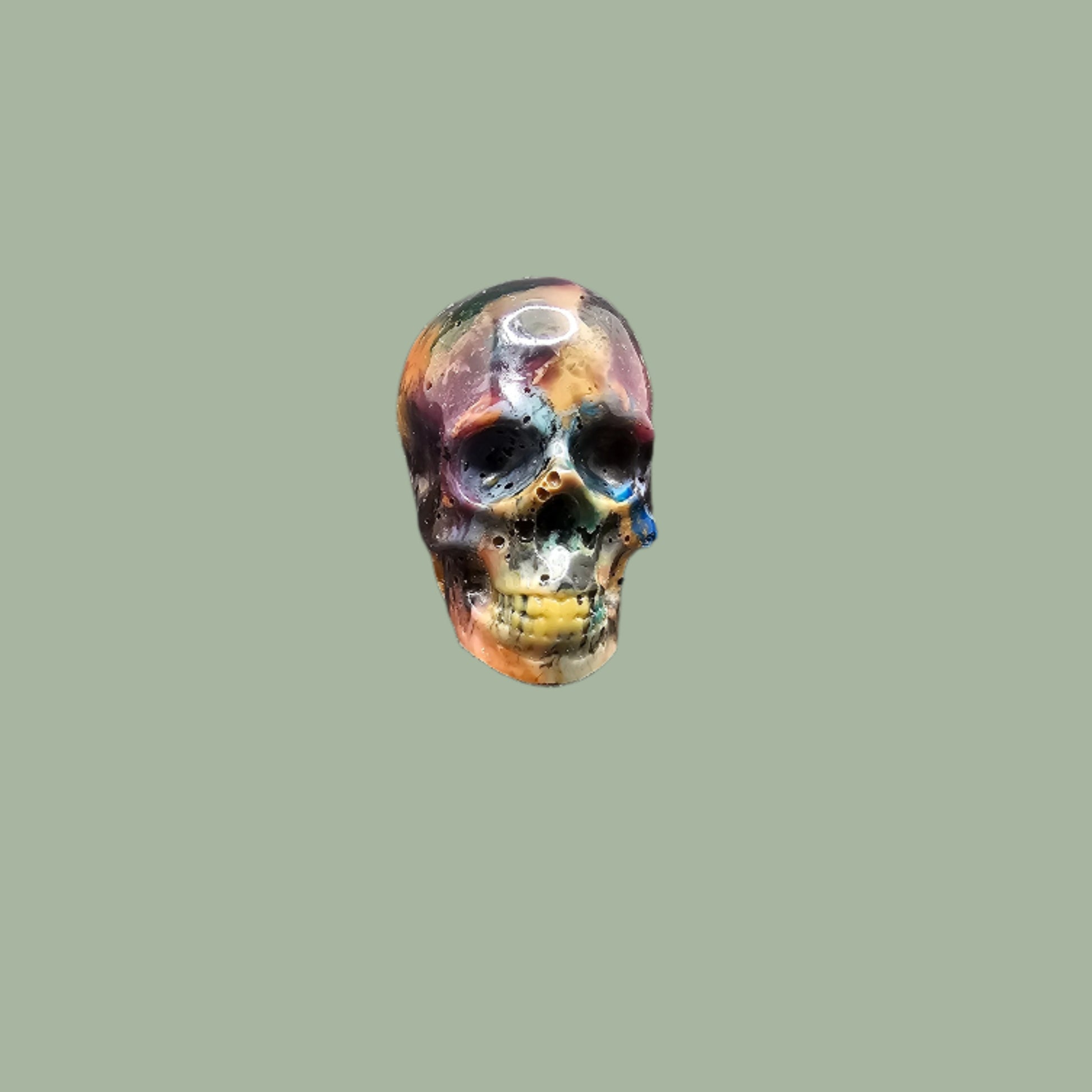 Colourful recycled filament skulls in large, medium, and small sizes, made from 3D printing waste. Each skull is unique, featuring a mix of random colours. Eco-friendly and sustainable home decor