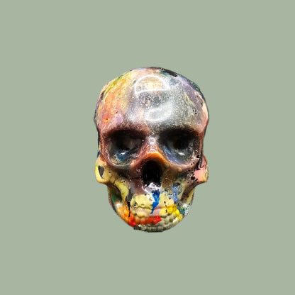 Colourful recycled filament skulls in large, medium, and small sizes, made from 3D printing waste. Each skull is unique, featuring a mix of random colours. Eco-friendly and sustainable home decor