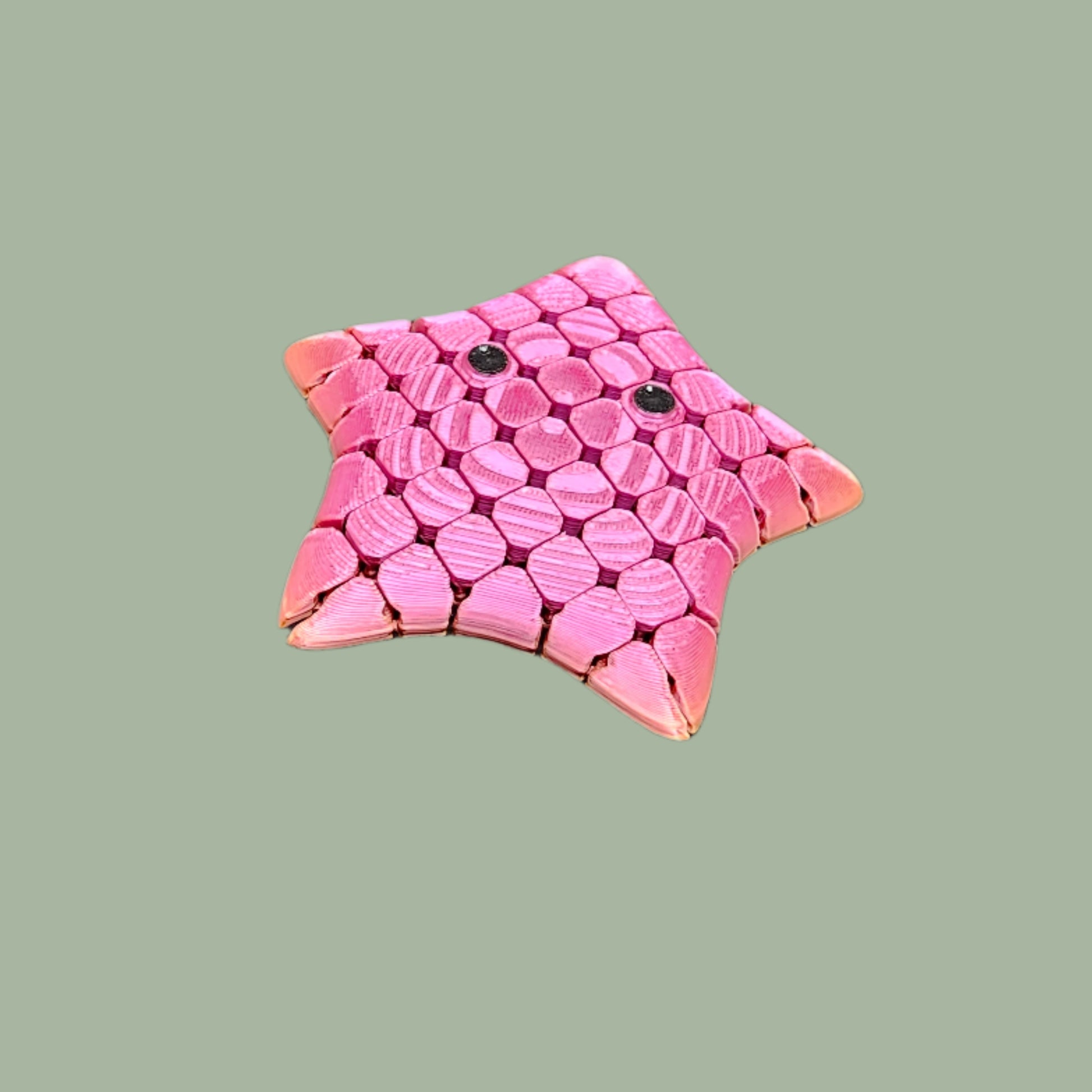 3D printed Flexi Starfish Mini, 9cm in size, featuring a honeycomb texture, articulated movement, and a cute smiling face. Supplied in a random colour, this pocket-sized fidget toy is exclusively reinforced for durability. Ideal for sensory play, stress relief, and ocean-themed gifts