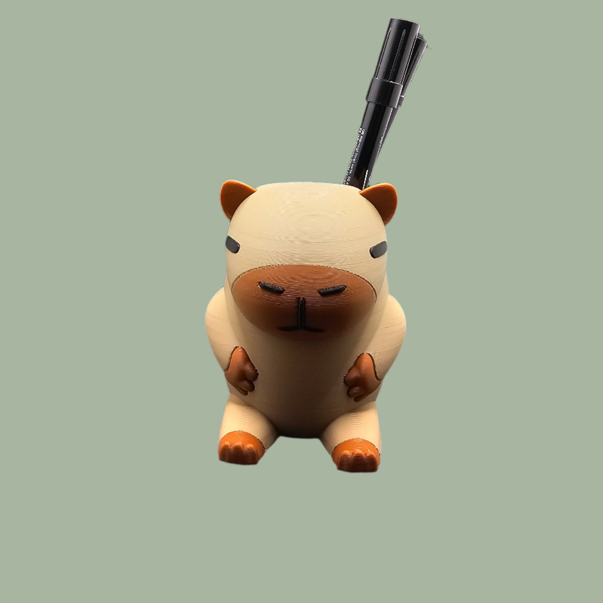 3D printed Capybara Pen Pot in a cute cartoon style, holding pens upright. A fun and functional desk organiser, designed and made in the UK. Perfect for stationery storage and office decor