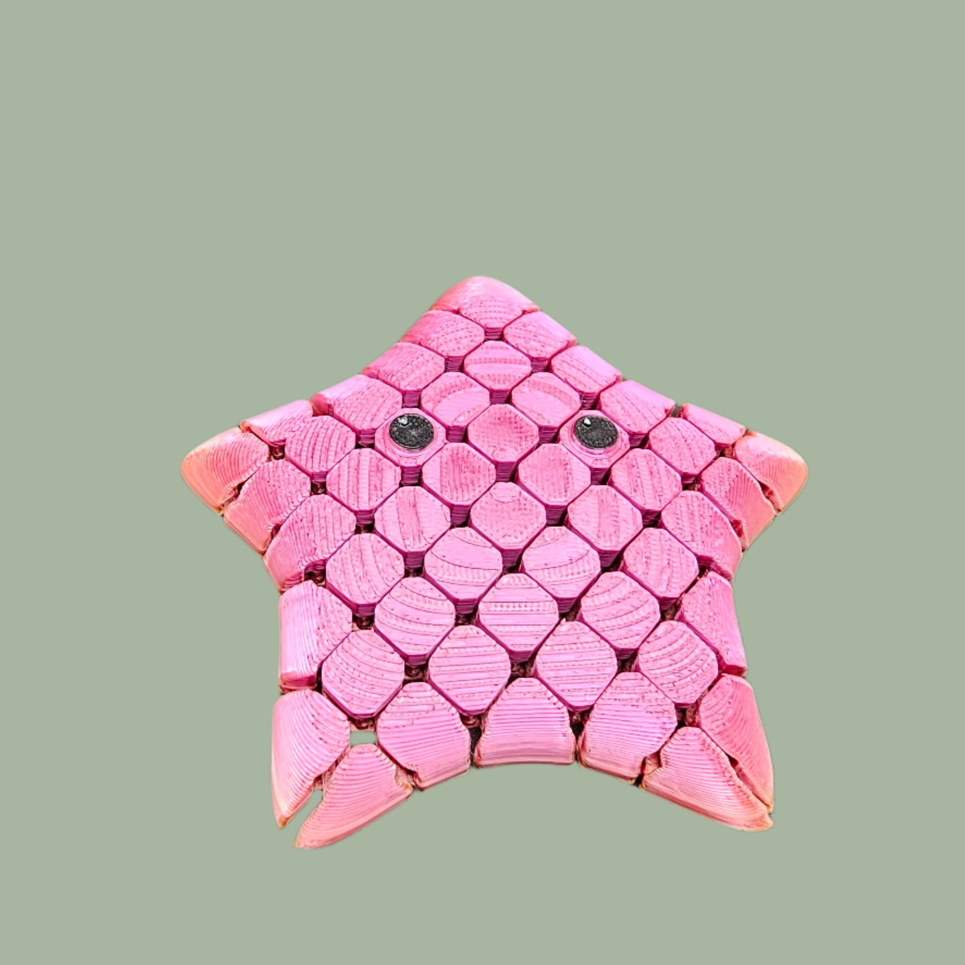3D printed Flexi Starfish Mini, 9cm in size, featuring a honeycomb texture, articulated movement, and a cute smiling face. Supplied in a random colour, this pocket-sized fidget toy is exclusively reinforced for durability. Ideal for sensory play, stress relief, and ocean-themed gifts