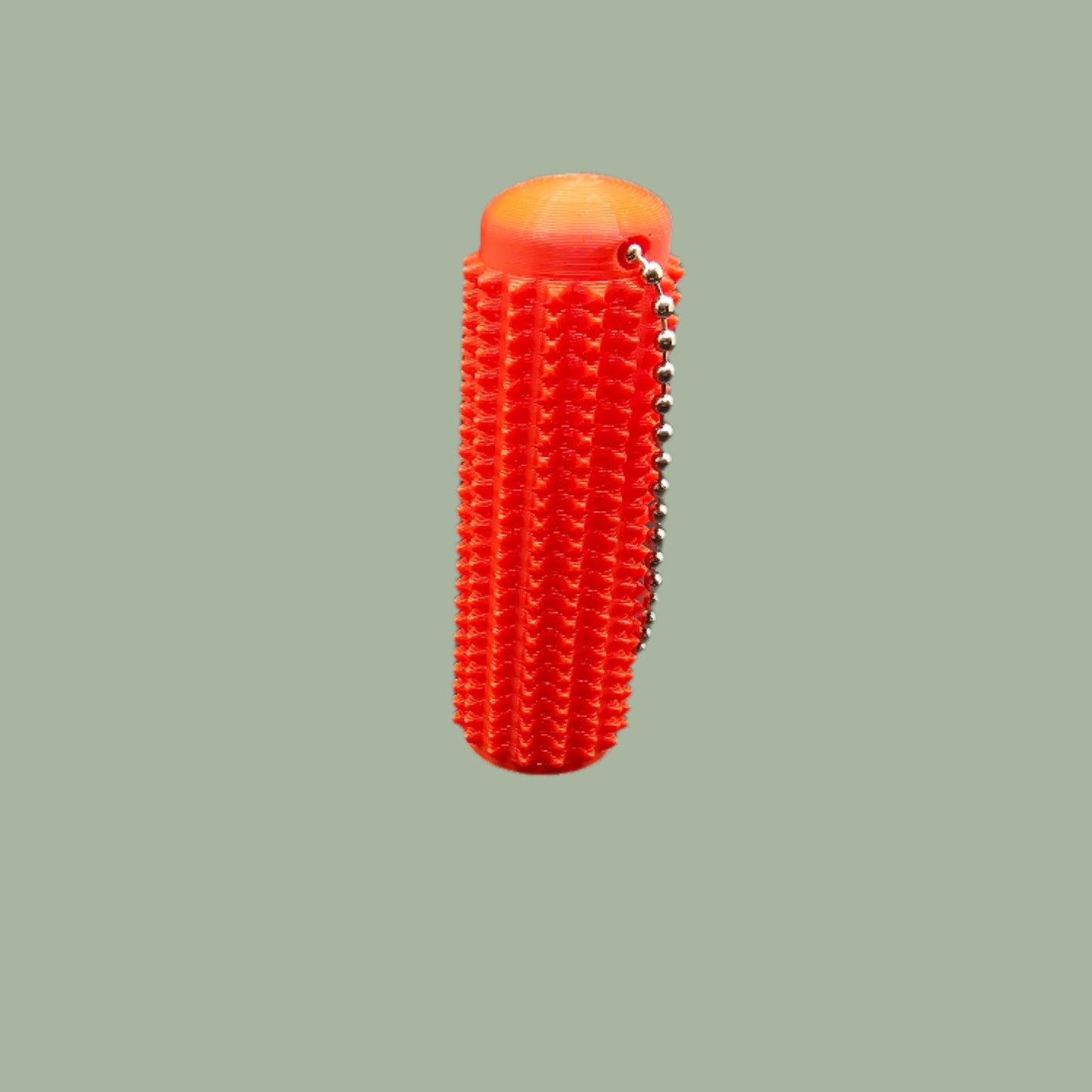 Mini Ouchie Pain Stim – a 7cm long, 3D-printed sensory tool with textured spikes for tactile stimulation, displayed against a neutral background. Includes a keychain for easy portability