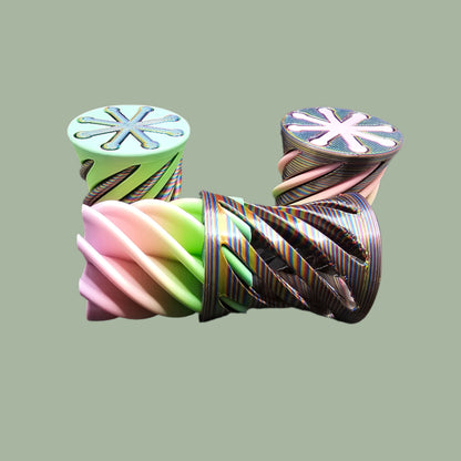 3D-printed Infinity Tubes in pastel and rainbow colours, featuring a spiral fidget design. Small, portable sensory toy made in the UK for stress relief and endless fidgeting